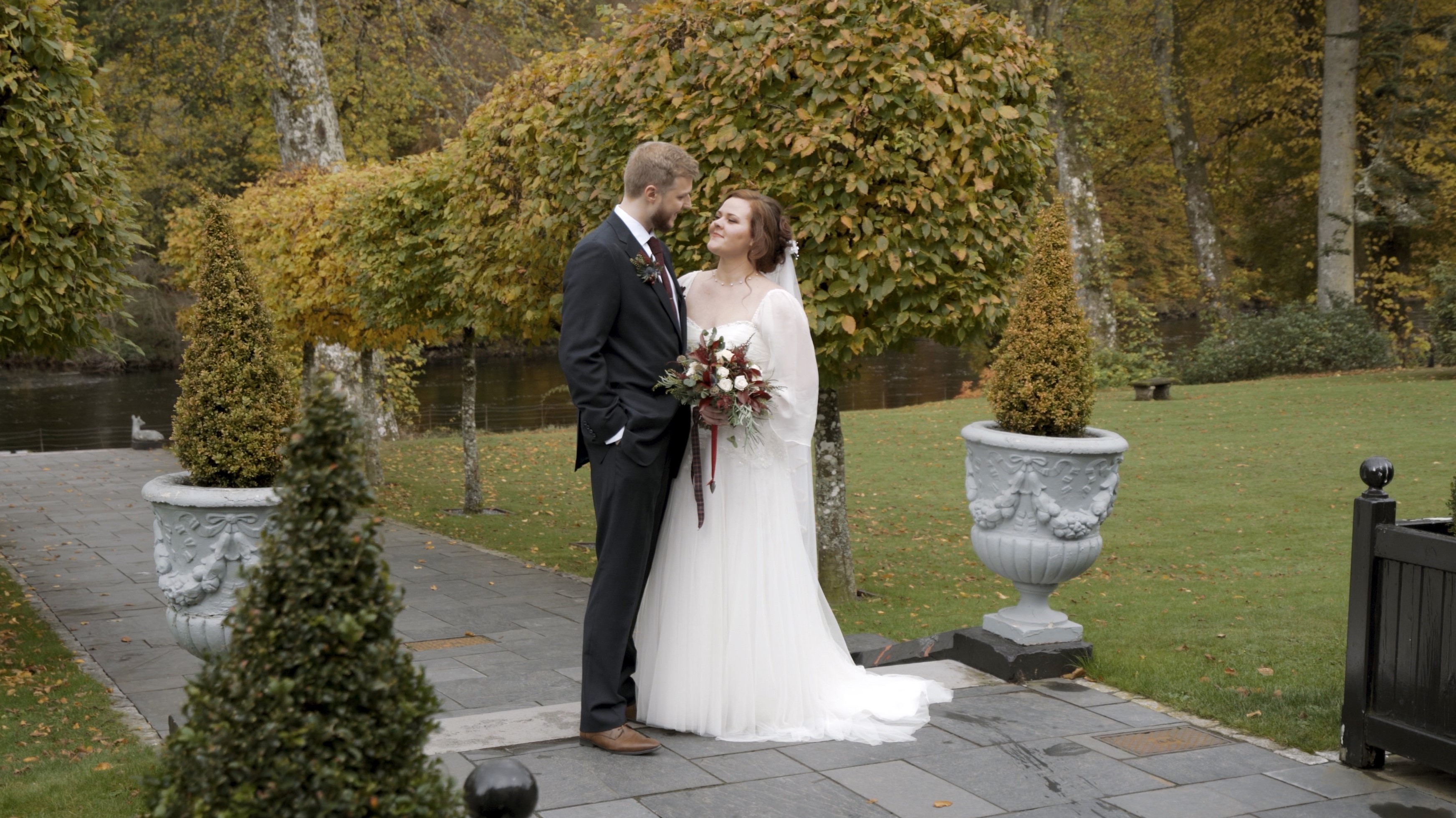 Bailey and Ilari, husband and wife standing in a garden